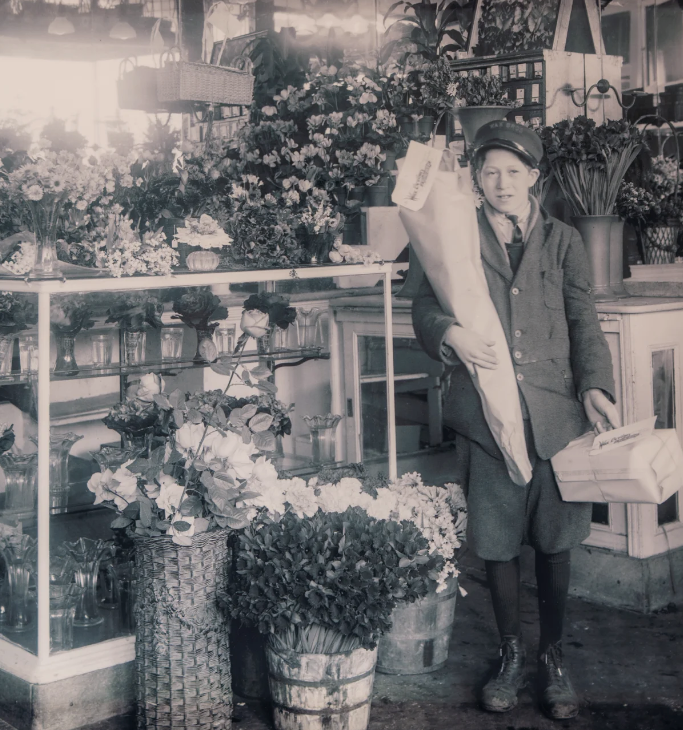Vintage photograph of a young florist delivery boy at The Royal Florist shop